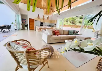 Stunning open-plan living room with modern decor and lush garden view, perfect for relaxation and entertaining.