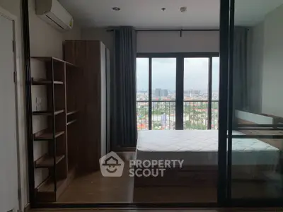 Modern bedroom with city view and large windows in high-rise apartment