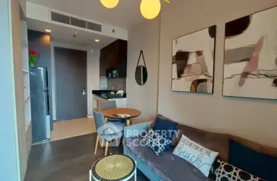 Modern living room with stylish decor and compact dining area in a cozy apartment.