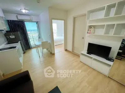 Modern open-plan living room with kitchen and bedroom view