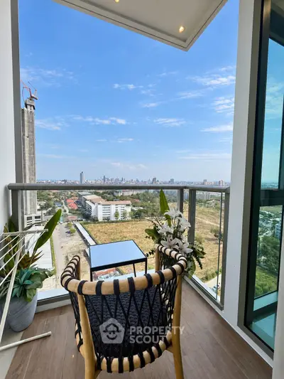 Stunning balcony view with modern chair and city skyline, perfect for relaxation and enjoying the outdoors.