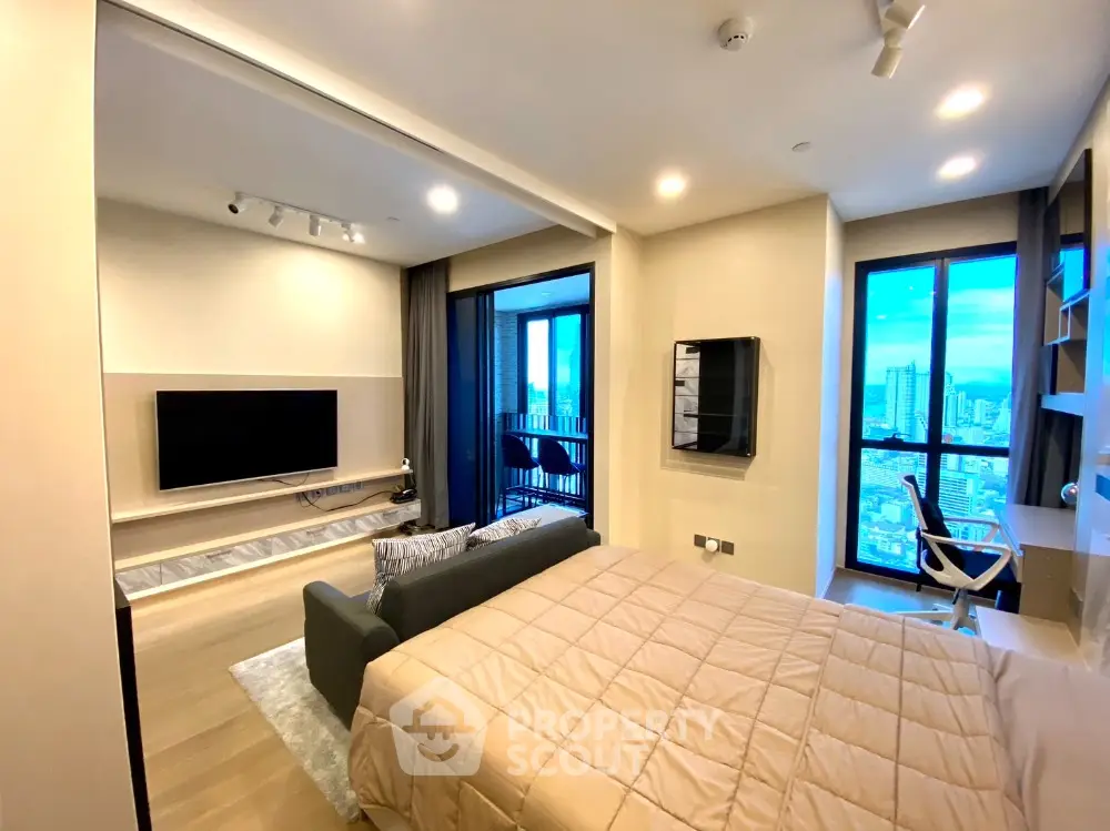 Modern studio apartment with city view, featuring a cozy living area and stylish decor.