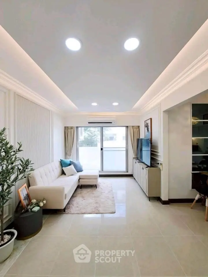 Modern living room with elegant decor, large windows, and stylish furniture in a bright apartment.