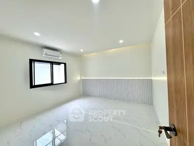 Spacious modern room with glossy tiled floor and air conditioning, perfect for a stylish living space.