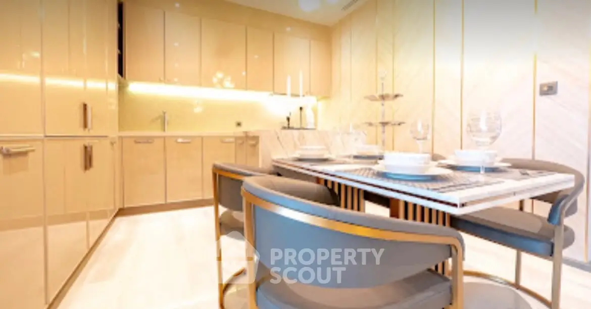 Luxurious modern kitchen with sleek cabinetry and elegant dining setup