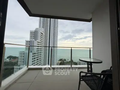 Stunning high-rise balcony with ocean view, perfect for relaxation and enjoying the skyline.