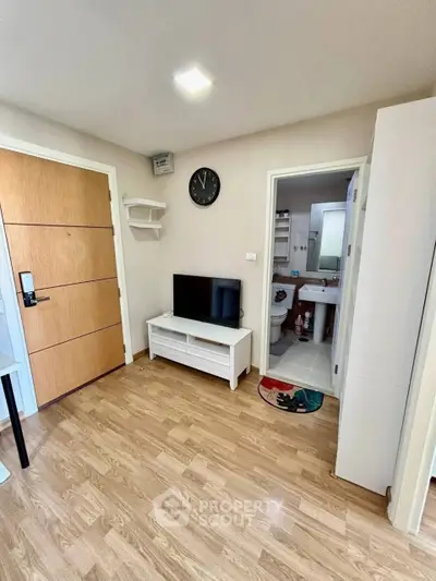 Modern apartment interior with wooden flooring and compact living area