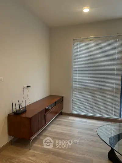 Modern living room with sleek wooden furniture and large window blinds