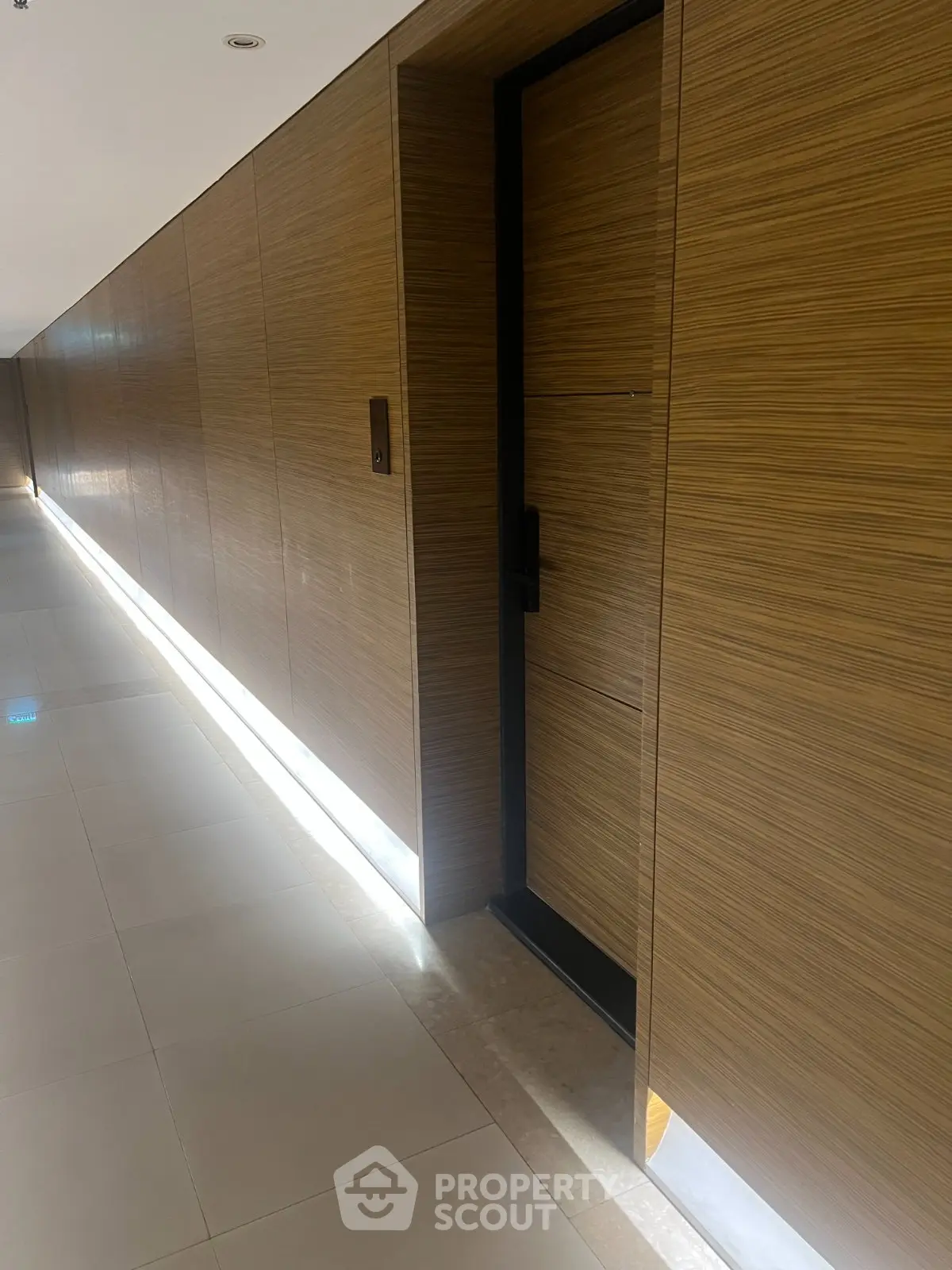 Sleek modern hallway with wooden paneling and ambient lighting