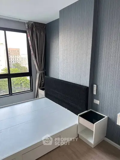 Modern bedroom with large window and stylish decor