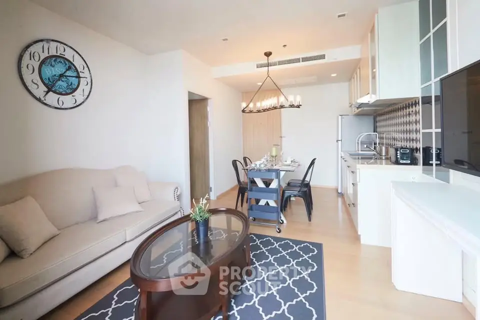 Modern open-layout living room and kitchen with elegant decor and dining area.