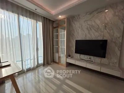 Modern living room with large windows and wall-mounted TV in a stylish apartment.
