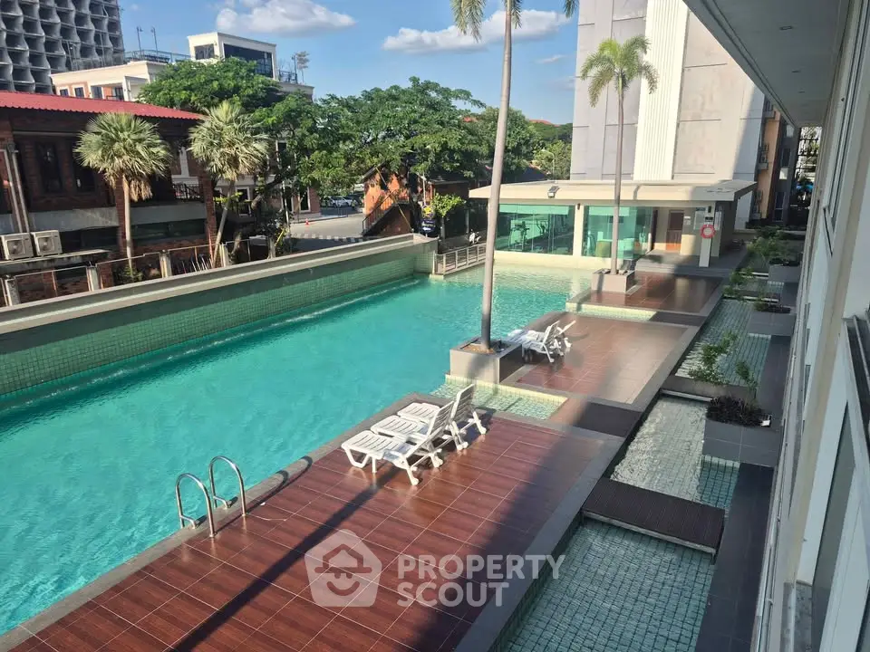 Luxurious outdoor pool area with sun loungers and modern design, perfect for relaxation and leisure.