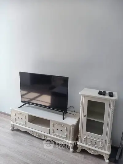 Elegant living room with classic white TV stand and cabinet, perfect for stylish home decor.