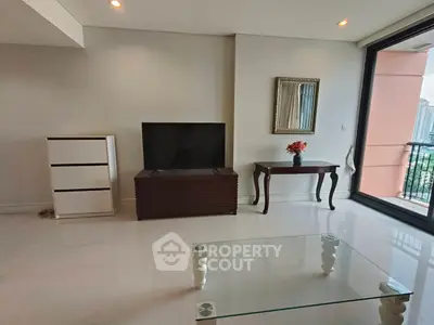 Spacious living room with modern decor and balcony view in luxury apartment