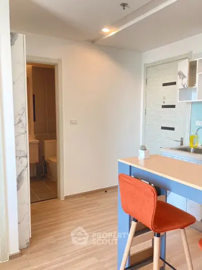 Modern apartment interior with open kitchen and stylish bar stool