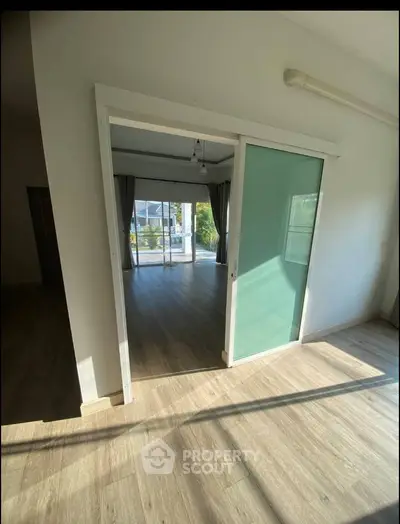 Spacious interior with sliding glass door and abundant natural light