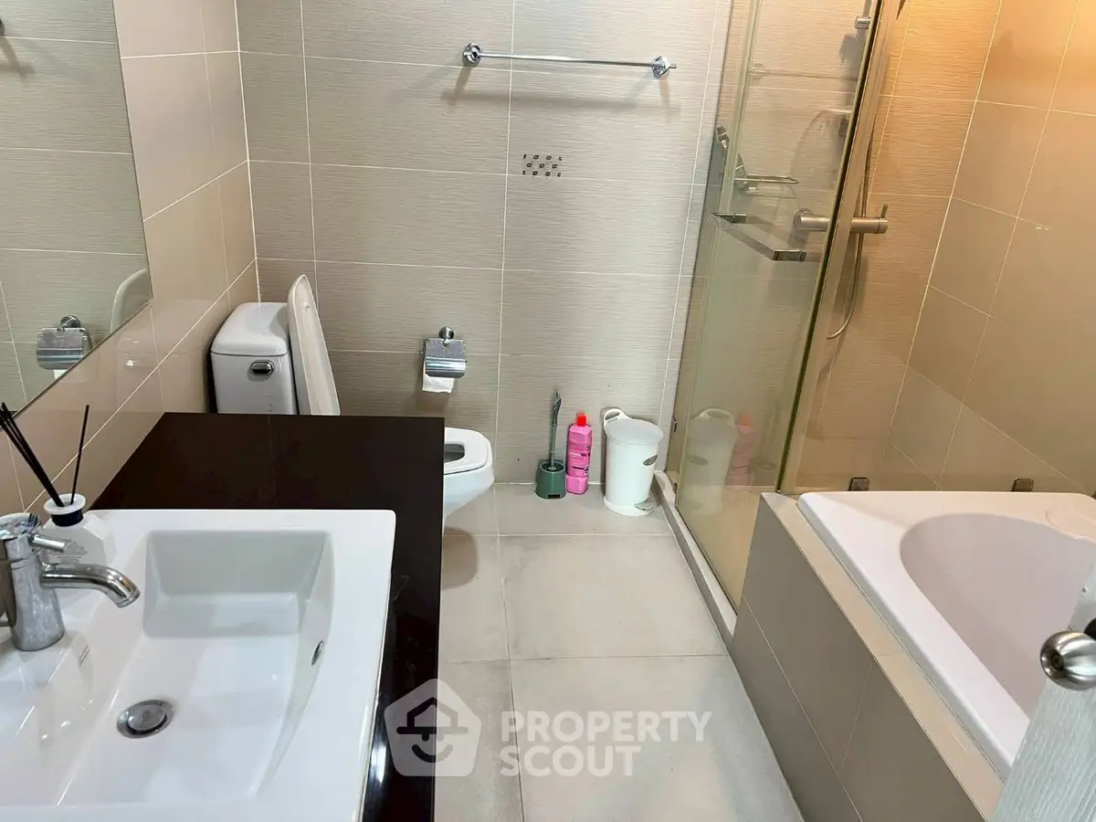 Modern bathroom with sleek fixtures and spacious shower area