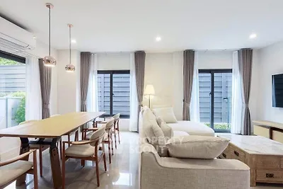 Spacious modern living room with elegant decor and ample natural light.