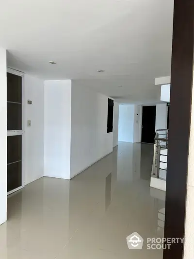 Spacious and bright living area with glossy tiled floors, modern lighting, and a versatile open layout perfect for customization in a luxurious home.