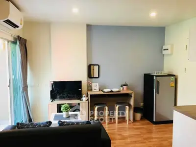 Modern living room with compact dining area and sleek appliances