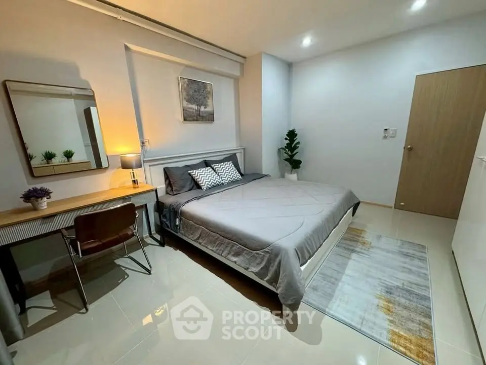 Modern bedroom with stylish decor and cozy ambiance, featuring a comfortable bed and elegant furnishings.