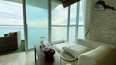 Luxurious living room with stunning ocean view and cozy seating area.