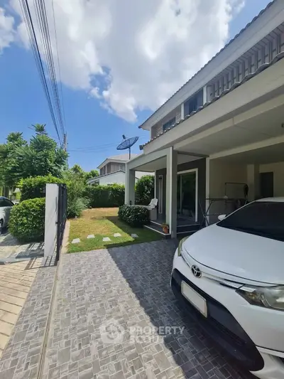 Charming suburban home with driveway and lush garden, perfect for family living.