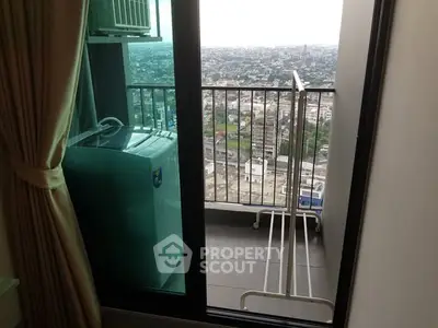 High-rise apartment balcony with city view and laundry area