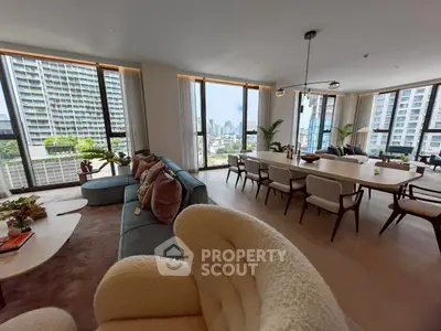 Luxurious open-plan living room with city view, modern furniture, and elegant dining area.