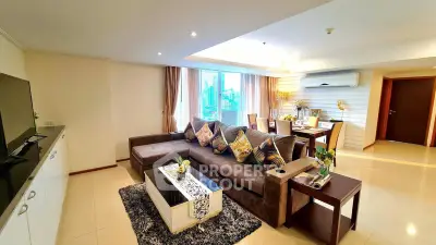 Spacious modern living room with city view, elegant decor, and cozy seating area.