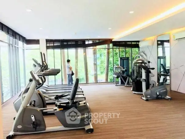 Modern gym with state-of-the-art equipment and floor-to-ceiling windows