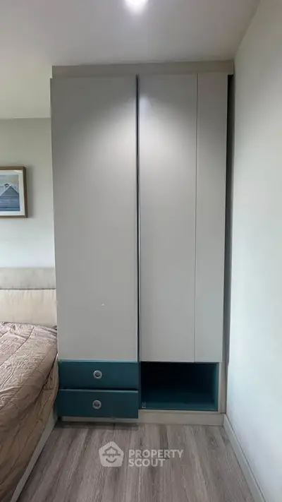 Modern bedroom with sleek wardrobe and cozy bed setup