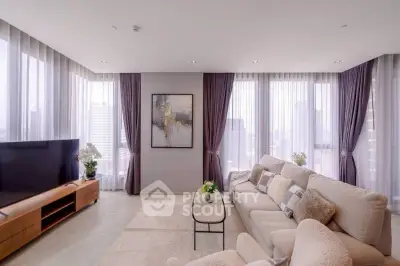 Spacious modern living room with panoramic city views and elegant decor.