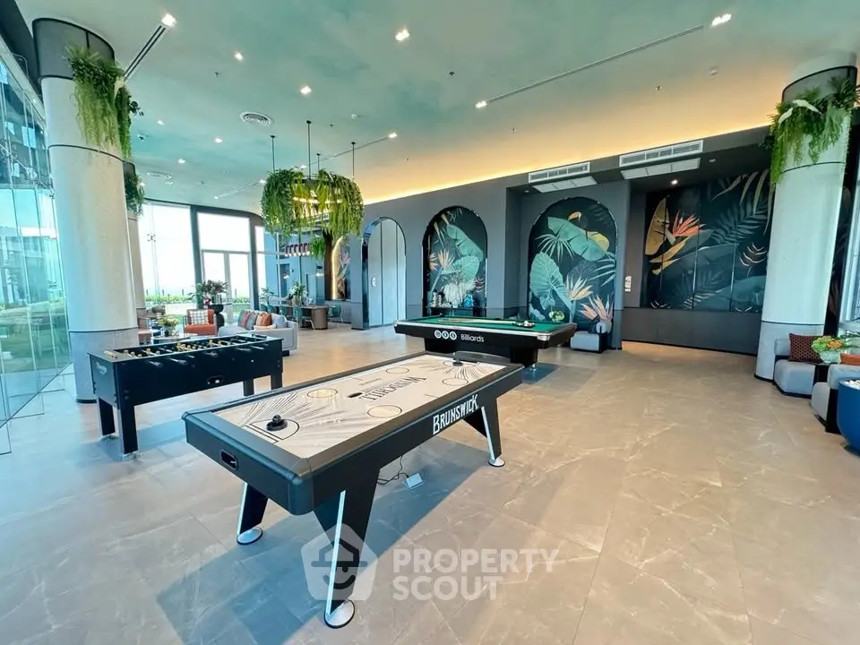 Luxurious game room with modern decor and vibrant wall art in upscale residential building.