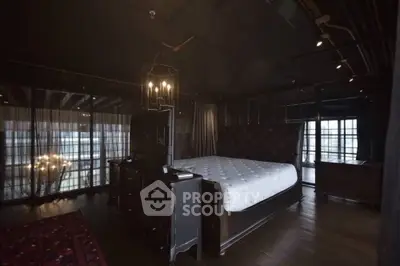 Luxurious dark-themed bedroom with elegant furnishings and ambient lighting.