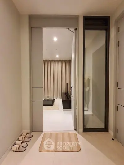 Modern apartment entrance with stylish decor and cozy living room view.