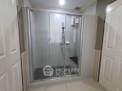 Modern bathroom with glass shower enclosure and sleek tile design