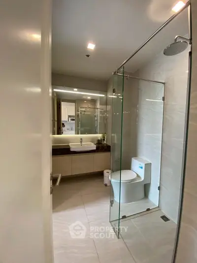 Modern bathroom with glass shower and sleek fixtures, perfect for contemporary living.