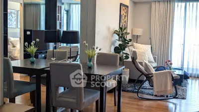 Modern living room with elegant dining area and cozy seating, featuring stylish decor and natural light.