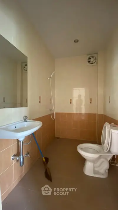 Spacious bathroom with modern fixtures and neutral tiles