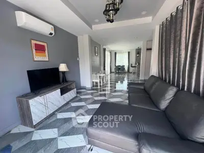 Modern living room with sleek furniture and stylish decor, featuring a spacious layout and contemporary design.