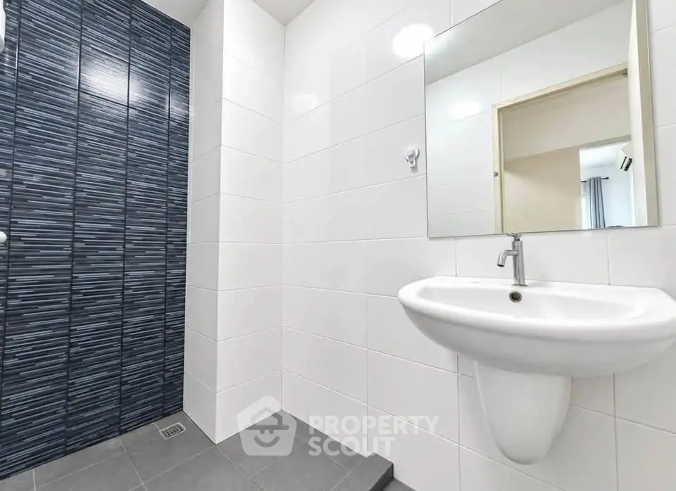 Modern bathroom with sleek white tiles and stylish sink design