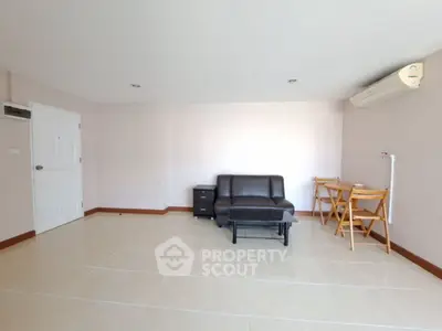 Spacious living room with modern furniture and air conditioning