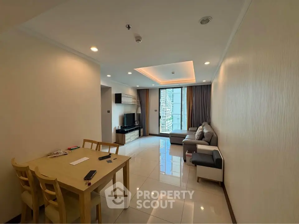 Spacious modern living room with city view, elegant furniture, and ample natural light in a high-rise apartment.