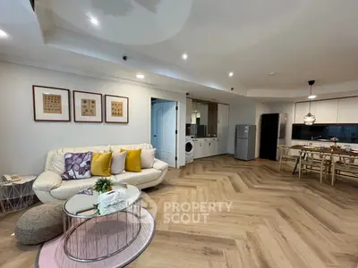 Spacious open-plan living room with modern kitchen and cozy seating area
