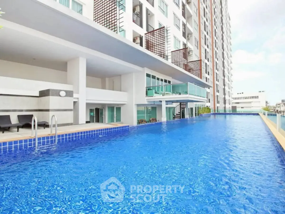 Luxurious condominium with stunning poolside view and modern architecture.