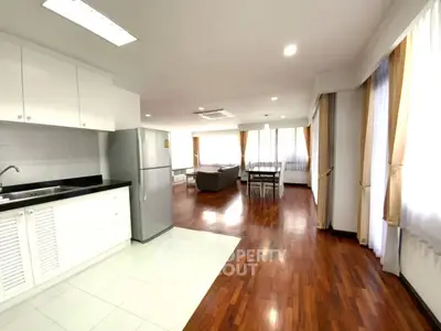 Spacious open-plan living area with modern kitchen and hardwood floors