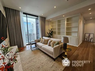 Elegant living room with hardwood floors, modern furniture, and access to a sunlit balcony, showcasing a perfect blend of comfort and style.