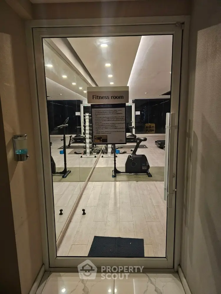Modern fitness room with gym equipment in a residential building